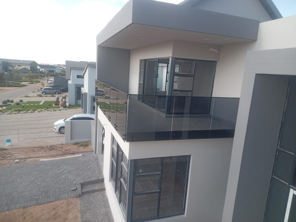 Modern two-storey house with balcony and glass balustrade