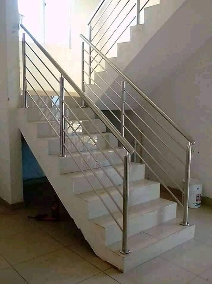 White staircase with stainless steel balustrade railing
