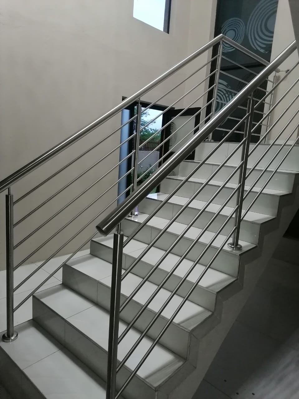 Interior staircase with custom stainless steel railing