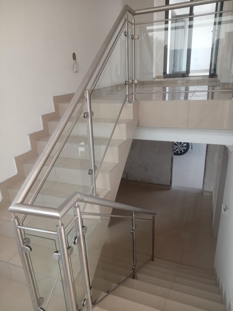 Tiled staircase with stainless steel and glass balustrade